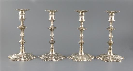 A set of four George II cast silver candlesticks by John Cafe, 73.5 oz.